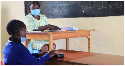 A teacher engaging with a vi learner using Orbit Reader 20