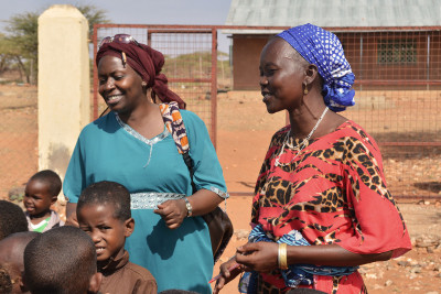 Kenyan teachers singing a traditional song with a group of children
