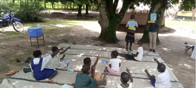 CHILDREN IN NORTHERN UGANDA LEARNING VIA RADIO AT A LISTENING CENTRE