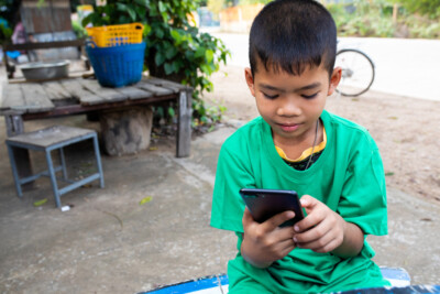 An,Asian,Child,Holding,Smartphone