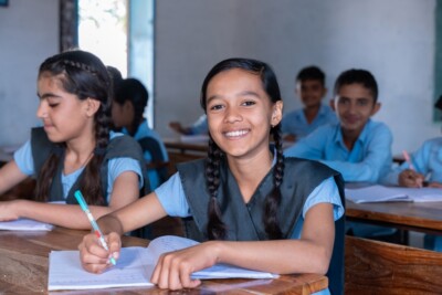 Group,Of,Girl,Students,In,School,Uniform,Sitting