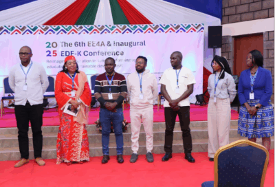 A group of people from the Unlocking Data team stand together at an event
