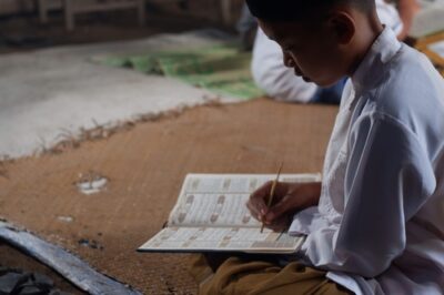 Child reading a book and circling some of the content